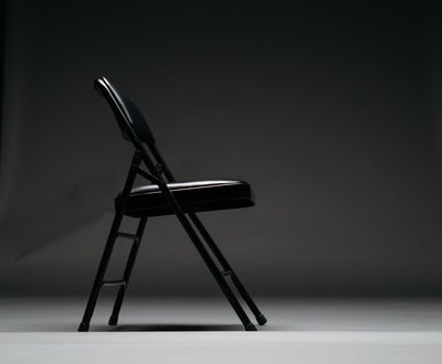 A folding chair in a studio (Photo by Keagan Henman on Unsplash)